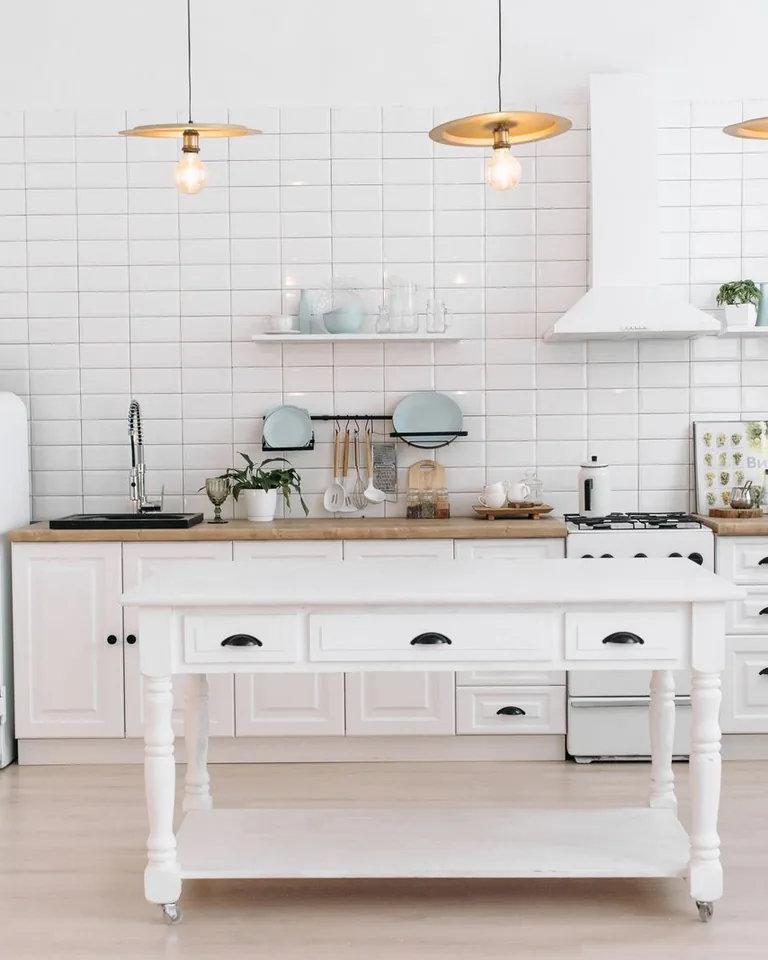 Minimalist kitchen with plants and pendant lights