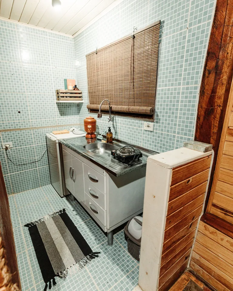 Kitchen with blue tile backsplash and wooden accents