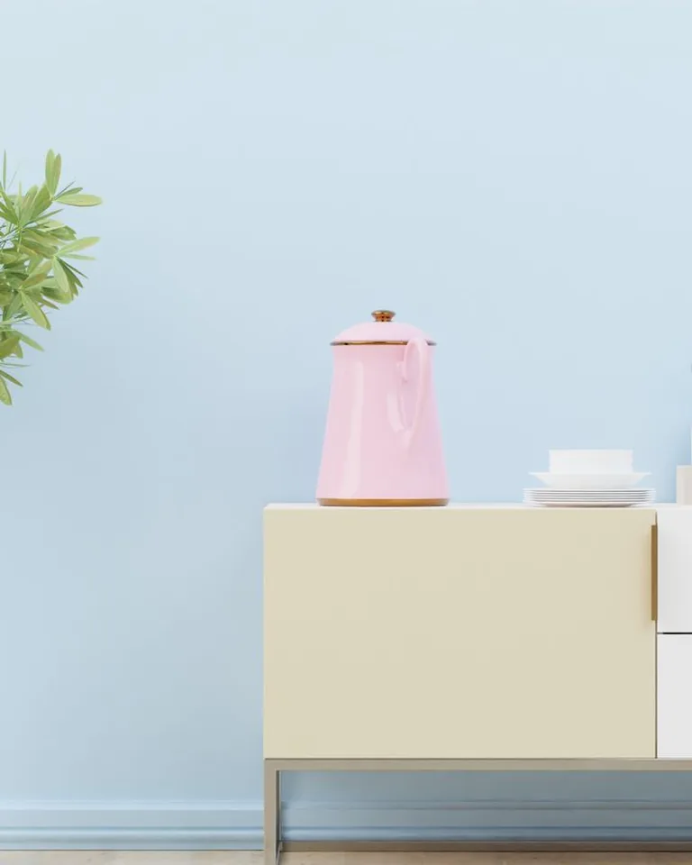 Pastel kitchenware styled with a small plant