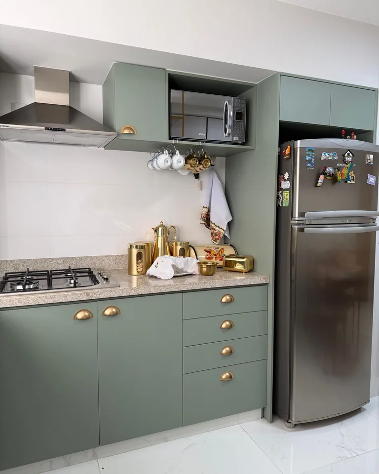 Kitchen with green cabinets and stainless steel appliances