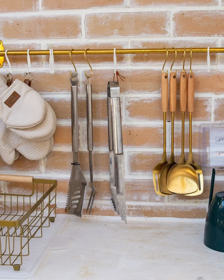 Kitchen utensils displayed on a metal rack