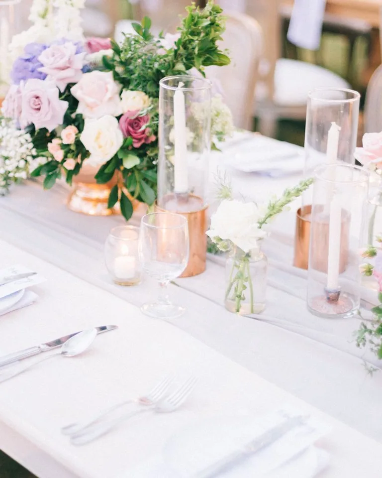 Beautifully arranged wedding table with floral centerpiece and candles