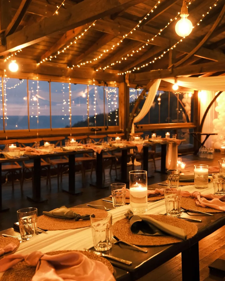 Warm, cozy dining setup with string lights and candles